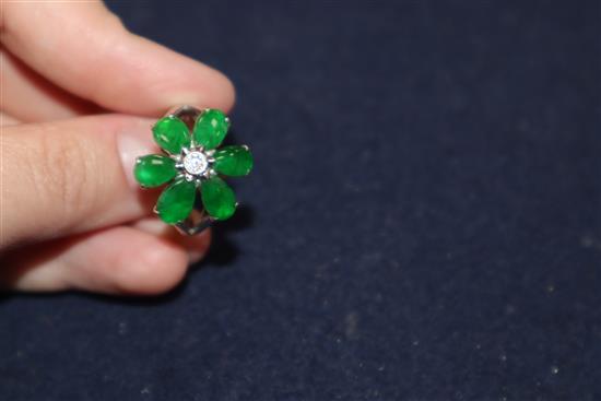 A modern 18k white metal, jadeite and diamond set flowerhead cluster ring, size P.